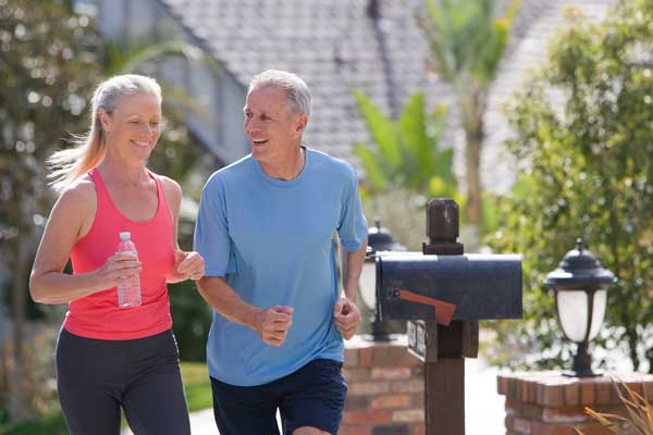 Mature couple walking through neighborhood